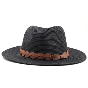 Detail of black woven sun hat featuring a classic brown braided leather decorative band