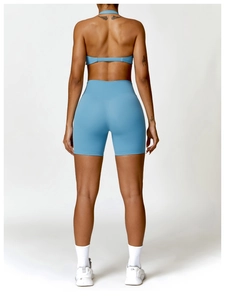 Back view of haze blue backless sports bra and high-waisted cycling shorts yoga set