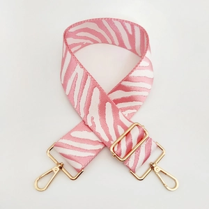 Detail of pink zebra print wide replacement shoulder strap with gold metal lobster clasps