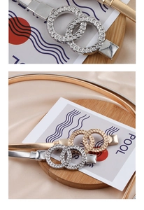 Detail of gold and silver elastic metal chain belts with double ring buckles on silk