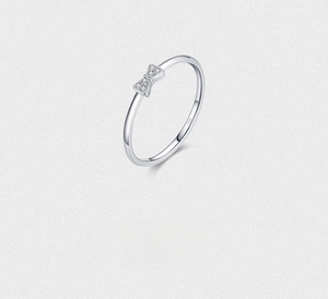 Close-up of S925 sterling silver bow ring with micro-pave white zircon stones