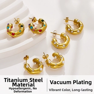 Detail of 18k gold plated stainless steel C-shaped earrings with pearls and gemstones