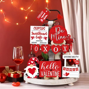 Close-up of tiered tray featuring Valentine's Day heart-themed wooden signs and ornaments