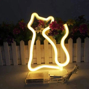 Detailed view of cat-shaped LED neon light with USB power cable on a dark background