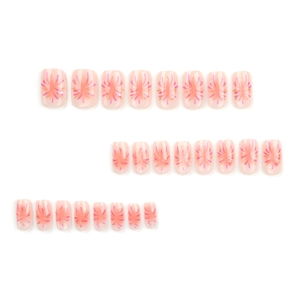 Pink press-on nail set featuring fireworks pattern with golden and pink radiant designs