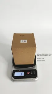 Kitchen scale weighing a boxed resin skull ornament for shipping measurement