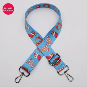 Detail of sky blue Christmas pattern wide bag strap with gingerbread man and gunmetal hooks