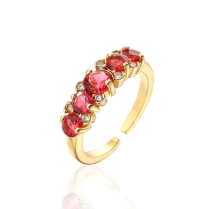 Detail of 18K gold plated ring featuring five red heart-cut cubic zirconia and white gems