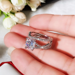Close-up of classic silver split-shank ring with large round zircon and pavé diamonds