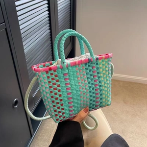 Colorful handmade woven bucket bag with mint green pattern, top handles and shoulder strap
