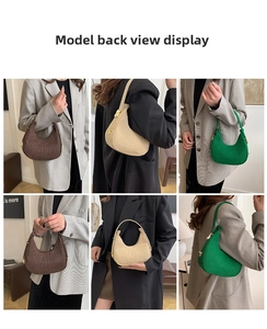 Detail view of crescent felt handbags with crocodile embossed texture and metal buckles