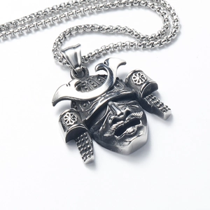 Close-up of retro silver stainless steel samurai helmet pendant with textured details