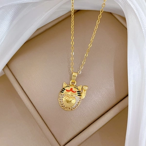 Detailed view of luxury fortune cat pendant with sparkling crystals on gold necklace