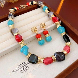 Vintage jewelry set with irregular colorful beads and gold metal necklace and earrings
