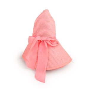 Detail of pink woven straw hat featuring a large ribbon bow and fine textured weave