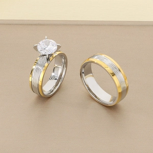 Detail of two-tone gold and silver couple rings with four-prong set cubic zirconia
