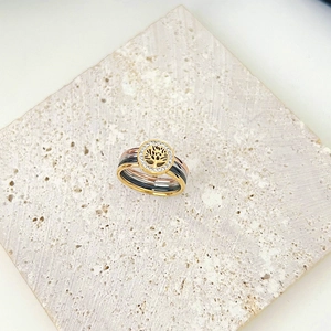 Elegant set of multi-color Tree of Life rings with sparkling crystals on stone background