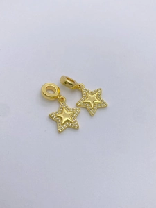 Detailed view of two gold starfish pendants with white cubic zirconia micro-inlay edges