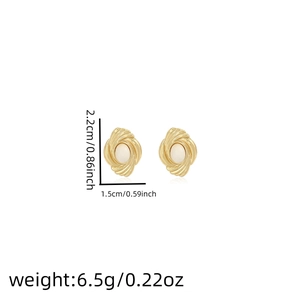 Detail showing vintage gold swirl earrings with white pearl inlay and size specifications