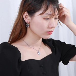 Silver stainless steel jewelry set featuring hollow star and moon charms on model