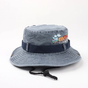 Detail of embroidered cartoon train on cotton denim sun hat with ventilation eyelets