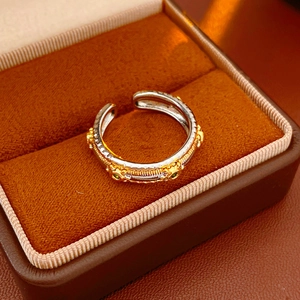 Detail of vintage oval adjustable ring featuring a green gemstone on jewelry box