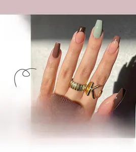 Detail of French press-on nails in brown and nude tones with long coffin shape