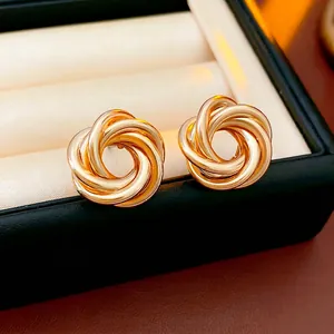 Polished gold geometric intertwined knot earrings with a spiral woven minimalist design