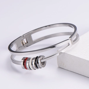 Silver stainless steel bangle featuring tricolor red, black, and white enamel rings