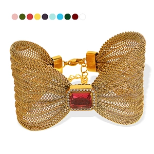 Elegant gold mesh bow bracelet with large red zircon and sparkling diamond edging details
