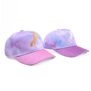 Detail of kids unicorn baseball caps with tie-dye marble patterns and glitter brims