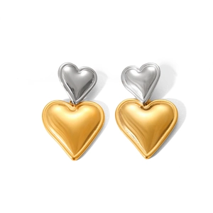 Close-up of heart-shaped drop earrings in gold and silver plated stainless steel