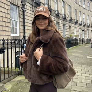 Dunkelbraune Kunstpelzjacke mit flauschiger Textur und modischem winterlichem Streetstyle