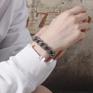 Retro gothic skull engraved stainless steel chain bracelet worn on male wrist
