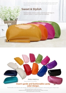 Detailed close-up of shell-shaped patent leather makeup bags in diverse candy colors