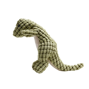 Close-up of green plush dinosaur dog toy with textured corn velvet fabric for teeth cleaning