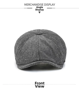 Front view of grey herringbone newsboy cap featuring detailed wool texture and classic style
