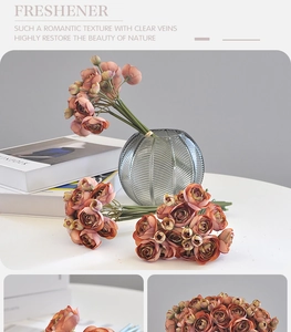 Close-up of coral ranunculus faux flowers in a glass vase for home decor