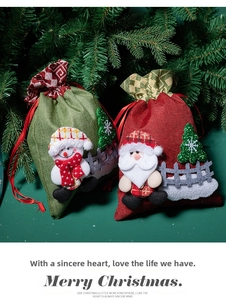 Detail of Christmas drawstring gift bags with 3D Santa and Snowman applique on burlap texture