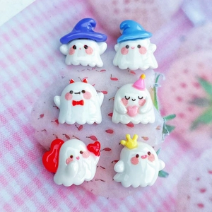 Close-up of six resin ghost figurines with colorful hats and hearts for DIY accessories