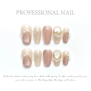 Handmade press-on nails set with pink cat-eye effects, pearls and rhinestone accents