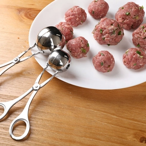 304 stainless steel meatball maker tool with spherical head on rustic wooden surface