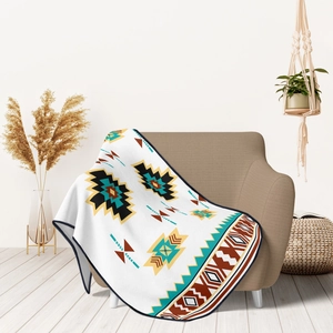 Soft flannel throw blanket with geometric tribal patterns on a cozy armchair