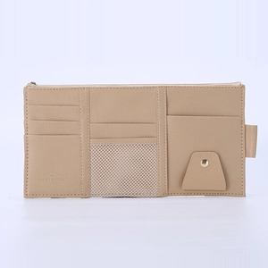 Beige PU leather car sun visor organizer with card slots and mesh pocket on white background