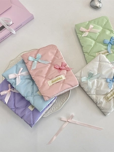 Quilted bow passport holder and card organizer in pastel colors like pink and mint green