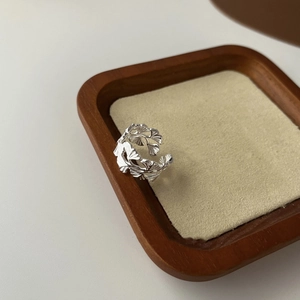 Macro detail of vintage S925 sterling silver open ring with intricate leaf texture