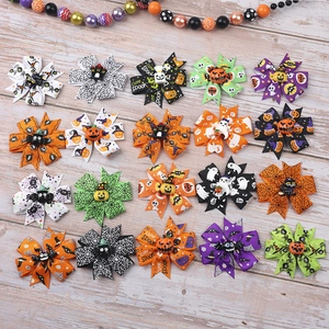 Detail of Halloween hair bows with spooky patterns like pumpkins, ghosts and spider webs