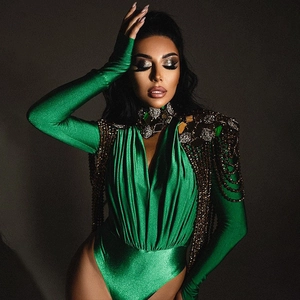 Detail of green long sleeve bodysuit with metallic sequins and hanging chain shoulder accents