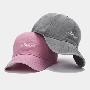 Pink and charcoal washed cotton baseball caps with Dragon embroidery in a stacked view