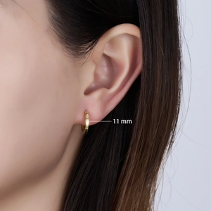 Detail view of 11mm polished gold hoop earring on model showing minimalist daily style